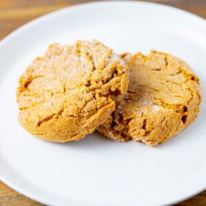 Two ginger molasses cookies on a plate. These cookies are available at Simply Baked Catering in Winchester, Ontario.