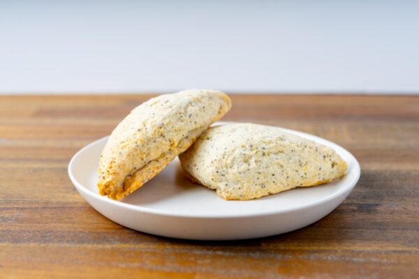 Two lemon lavender scones on a plate. These delicious scones are available at Simply Baked Catering Inc. in Winchester, Ontario.