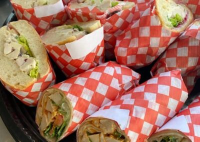 Image of a platter of chicken Caesar wraps, individually wrapped and ready to serve for a meeting or event. By Simply Baked Catering Inc., Winchester, Ontario.